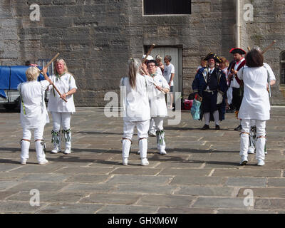 female morris dancers perform their traditional dance in Portsmouth, England Stock Photo