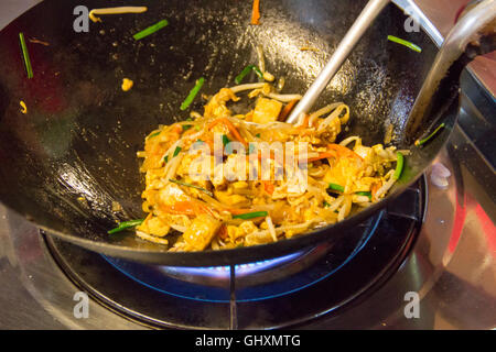 Stir frying Pad Thai ingredients in a wok on a hot stove. Stock Photo