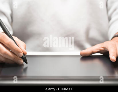 Close up of the hand of a graphic designer holding an electronic stylus. Background with free space for text, horizontal image Stock Photo