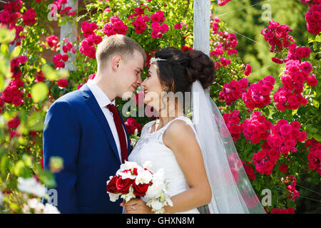 Wedding couple in the flowers at summer time Stock Photo