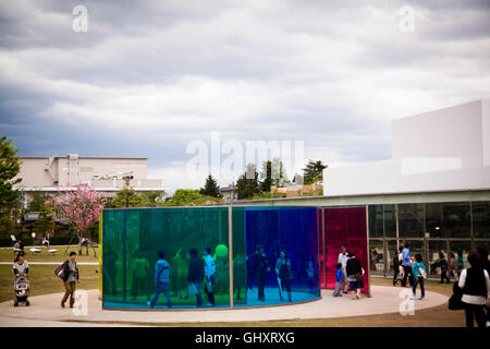 Visitors walk through an installation of coloured glass at the museum of modern art in Kanazwa, Japan Stock Photo