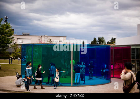 Visitors walk through an installation of coloured glass at the museum of modern art in Kanazwa, Japan Stock Photo