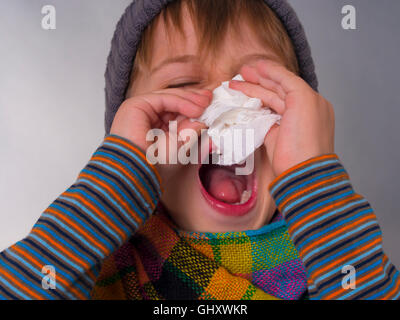 boy wiping his nose Stock Photo