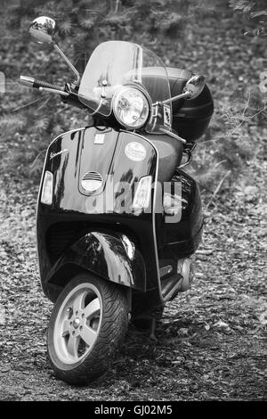 Kotka, Finland - July 16, 2016: Classical Italian scooter Vespa by Piaggio, black and white vertical photo Stock Photo