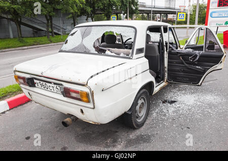 Saint-Petersburg, Russia - August 6, 2016: Crushed white VAZ-2106 car with broken windows and smashed doors, rear view Stock Photo