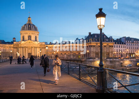 People Walking on the Pont des Arts at dusk, Paris, France Stock Photo