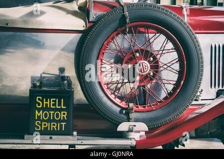 1929 MG car spare wheel and oil can at Bicester Heritage Centre. Oxfordshire, England. Vintage filter applied Stock Photo