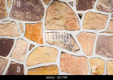 Exterior multi-coloured stone wall facade Stock Photo