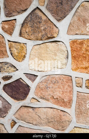 Exterior multi-coloured stone wall facade - vertical shot Stock Photo