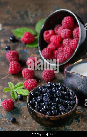 Bowls of raspberries and blueberries Stock Photo