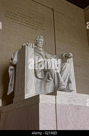 Figure of the president Abraham Lincoln is situated in the capital of the United States, Washington D.C. The monument is made from the marble and is 19 feet 5.8 m tall. Stock Photo