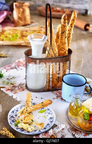 Bread sticks with milk, breakfast rustic setting on a wooden table. Stock Photo