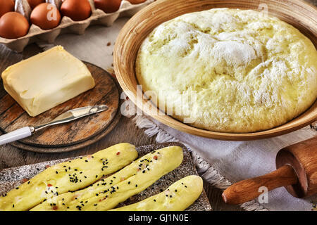 Yeast dough and bread sticks ready for baking. Stock Photo