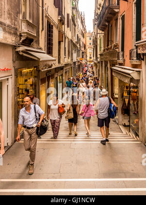 Tourists and shoppers in a narrow street in Venice, Italy. Stock Photo