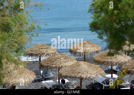 The beach with black volcanic stones at Santorini island, Greece Stock Photo