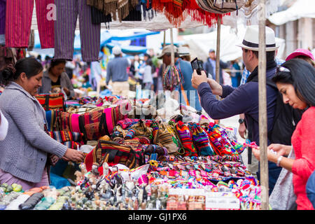 Pisac, Peru - May 15: Tourists shopping for souvenirs and local crafts at the Sacred Valley Market. May 15 2016, Pisac Peru. Stock Photo