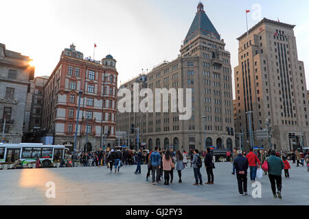 Shanghai, China: March 26, 2016: Tourists walking in the Bund, the most scenic spot in Shanghai. On background the most famous C Stock Photo