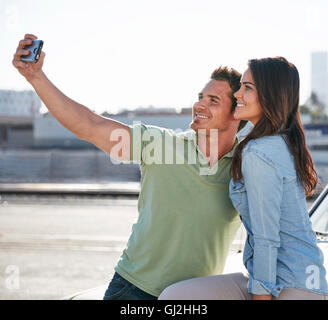 Couple by river taking selfie smiling Stock Photo