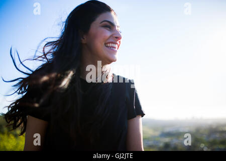 Young woman in rural setting, laughing Stock Photo