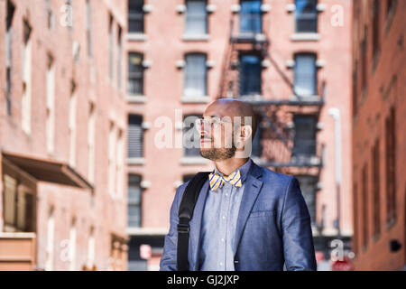 Businessman outdoors, looking away Stock Photo