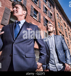 Two businessmen walking outdoors, low angle view Stock Photo