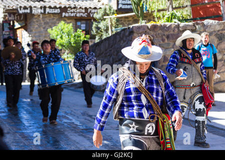 Ollantaytambo, Peru - May 16 : Religious celebration for Fiestas de Pentecostes with musicians marching on the streets of Ollant Stock Photo
