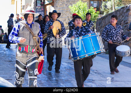 Ollantaytambo, Peru - May 16 : Religious celebration for Fiestas de Pentecostes with musicians marching on the streets of Ollant Stock Photo