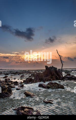 Colourful sunrise and sand  when sea water left during low tide Stock Photo