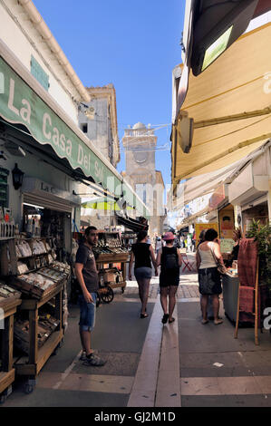 Walk through a pedestrian shopping street of Saintes-Maries-de-la-Mer in full summer. Stock Photo