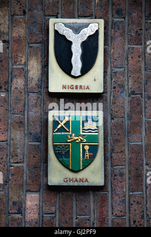 The national crests / coat of arms / emblems of Ghana and Nigeria as displayed on the International Hall's exterior. London Stock Photo