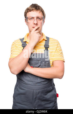 portrait of a pensive master in overalls on a white background Stock Photo