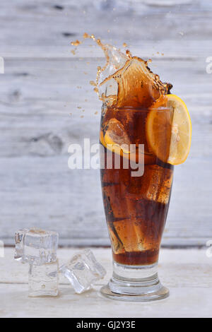 A glass of cola with ice cubes and a slice of lemon Stock Photo - Alamy
