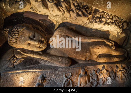 Reclining Buddha in chaitya-griha or prayer hall in Cave 26. Part of 29 rock-cut Buddhist cave monuments at Ajanta Caves. Part o Stock Photo