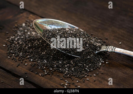 Spoonful of chia seeds (Salvia hispanica) on table Stock Photo