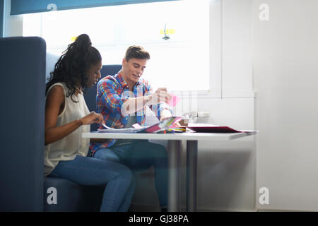 Young female and male college students planning with adhesive notes Stock Photo