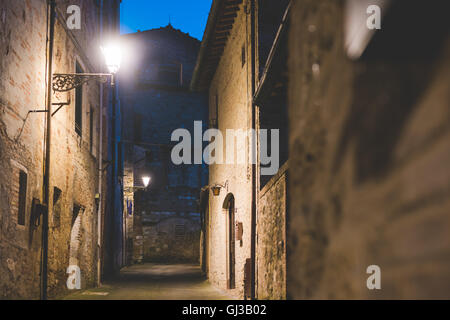 Streetlamps and alley at dusk, Colle di Val d'Elsa, Siena, Italy Stock Photo