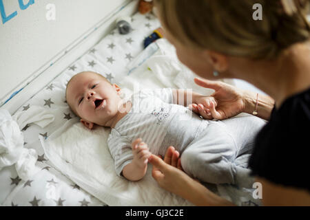 Over the shoulder view of mother communicating with baby son Stock Photo