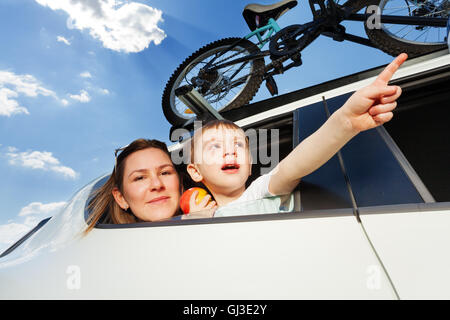 Young mother and her kid travelling by car Stock Photo