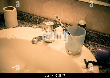 Bathroom sink in messy condition, a single male lifestyle concept Stock Photo