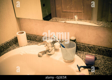 Bathroom sink in messy condition, a single male lifestyle concept Stock Photo