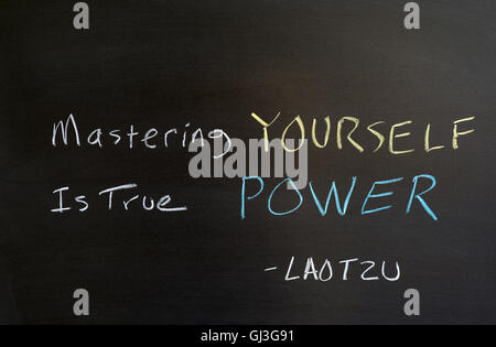 Quote by Lao Tzu. "Mastering yourself is true power" Written on chalkboard. Stock Photo