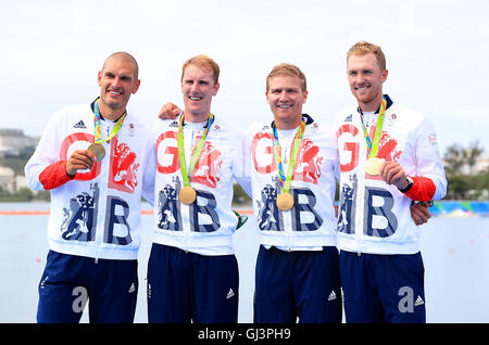 (left to right) Great Britain's Mohamed Sbihi, George Nash Alex Gregory and Constantine Louloudis celebrating winning the gold medal in the Men's Four Final at The Lagoa Stadium on the seventh day of the Rio Olympic Games, Brazil. Picture date: Friday August 12, 2016. Photo credit should read: Mike Egerton/PA Wire. RESTRICTIONS - Editorial Use Only. Stock Photo