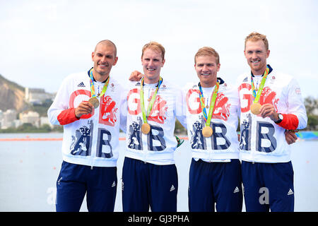 (left to right) Great Britain's Mohamed Sbihi, George Nash Alex Gregory and Constantine Louloudis celebrating winning the gold medal in the Men's Four Final at The Lagoa Stadium on the seventh day of the Rio Olympic Games, Brazil. Picture date: Friday August 12, 2016. Photo credit should read: Mike Egerton/PA Wire. Stock Photo