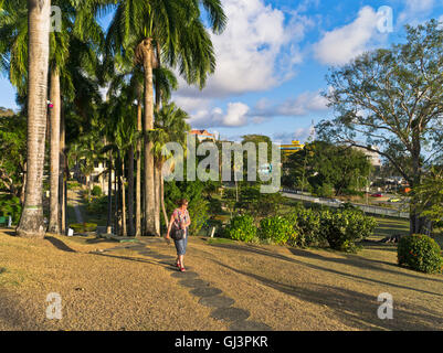 dh Scarborough Botanical Gardens TOBAGO CARIBBEAN Woman tourist on garden path tall palm trees botanic trinidad botanica Stock Photo