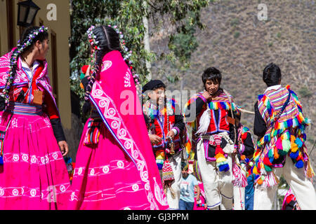 Ollantaytambo, Peru - May 16 : Religious celebration for Fiestas de Pentecostes with people wearing masks and colorful clothing  Stock Photo
