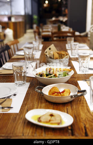 Spicy lakerda. Cheese pies. Green salad, Bread at Ergon restaurant and delicatessen, Thessaloniki, Greece Stock Photo