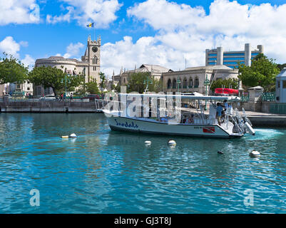 dh Bridgetown BARBADOS CARIBBEAN Tourist excursion boat Careenage anchorage harbour Parliament building Stock Photo