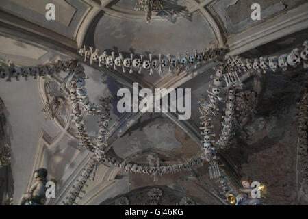 July 30, 2016 - Kutna Hora, Czech Republic - The Sedlec Ossuary ''Bone Church''.The Sedlec Ossuary is a small Roman Catholic chapel, located beneath the Cemetery Church of All Saints in Sedlec, a suburb of KutnÃ¡ Hora in the Czech Republic that displays some of the worldâ€™s more macabre art. It is one of twelve World Heritage Sites in the Czech Republic. The ossuary is estimated to contain the skeletons of between 40,000 and 70,000 people, whose bones have been artistically arranged to form decorations and furnishings for the chapel. The ossuary is among the most visited tourist attractions o Stock Photo