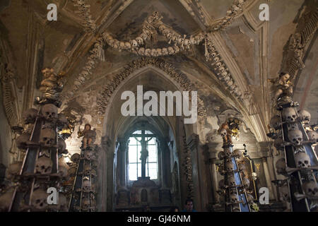 July 30, 2016 - Kutna Hora, Czech Republic - The Sedlec Ossuary ''Bone Church''.The Sedlec Ossuary is a small Roman Catholic chapel, located beneath the Cemetery Church of All Saints in Sedlec, a suburb of KutnÃ¡ Hora in the Czech Republic that displays some of the worldâ€™s more macabre art. It is one of twelve World Heritage Sites in the Czech Republic. The ossuary is estimated to contain the skeletons of between 40,000 and 70,000 people, whose bones have been artistically arranged to form decorations and furnishings for the chapel. The ossuary is among the most visited tourist attractions o Stock Photo