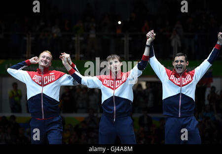 Rio De Janeiro, Brazil. 12th Aug, 2016. Russia's athletes attend the awarding ceremony for the men's foil team final of fencing at the 2016 Rio Olympic Games in Rio de Janeiro, Brazil, on Aug. 12, 2016. Russia won the gold medal. © Yin Bogu/Xinhua/Alamy Live News Stock Photo